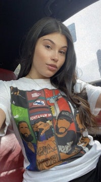 a woman in a car wearing a t - shirt