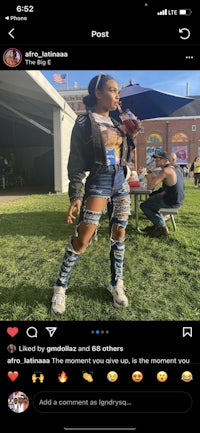 a woman wearing ripped jeans and a hat